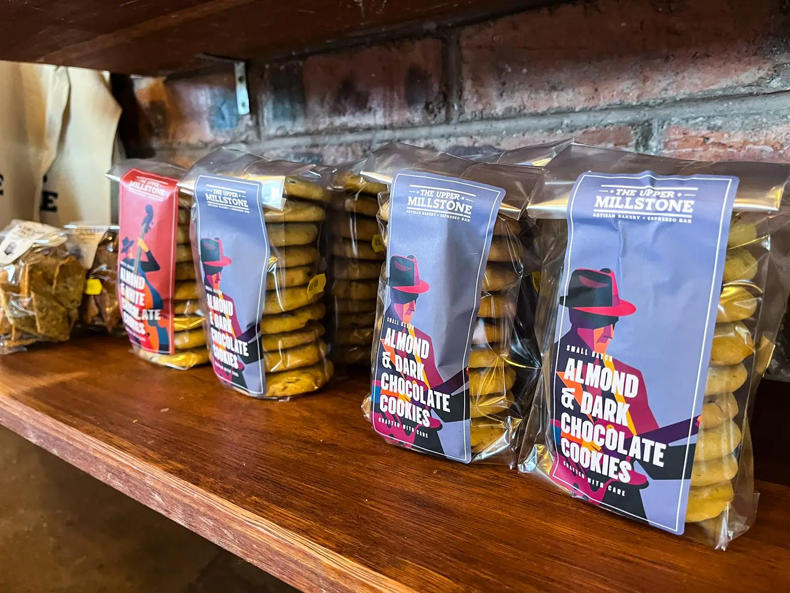 Packaged almond and dark chocolate cookies with musician-illustrated labels