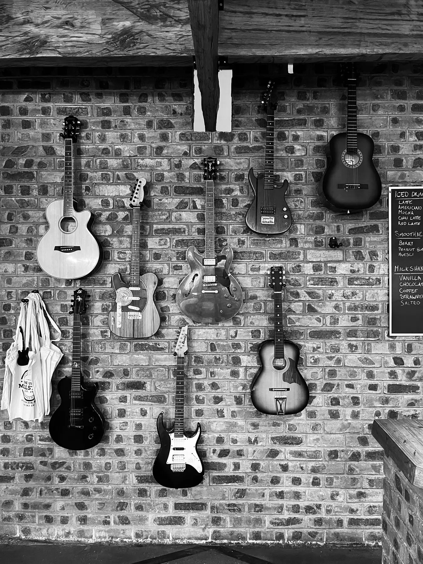 The wall of guitars at The Upper Millstone, in black and white