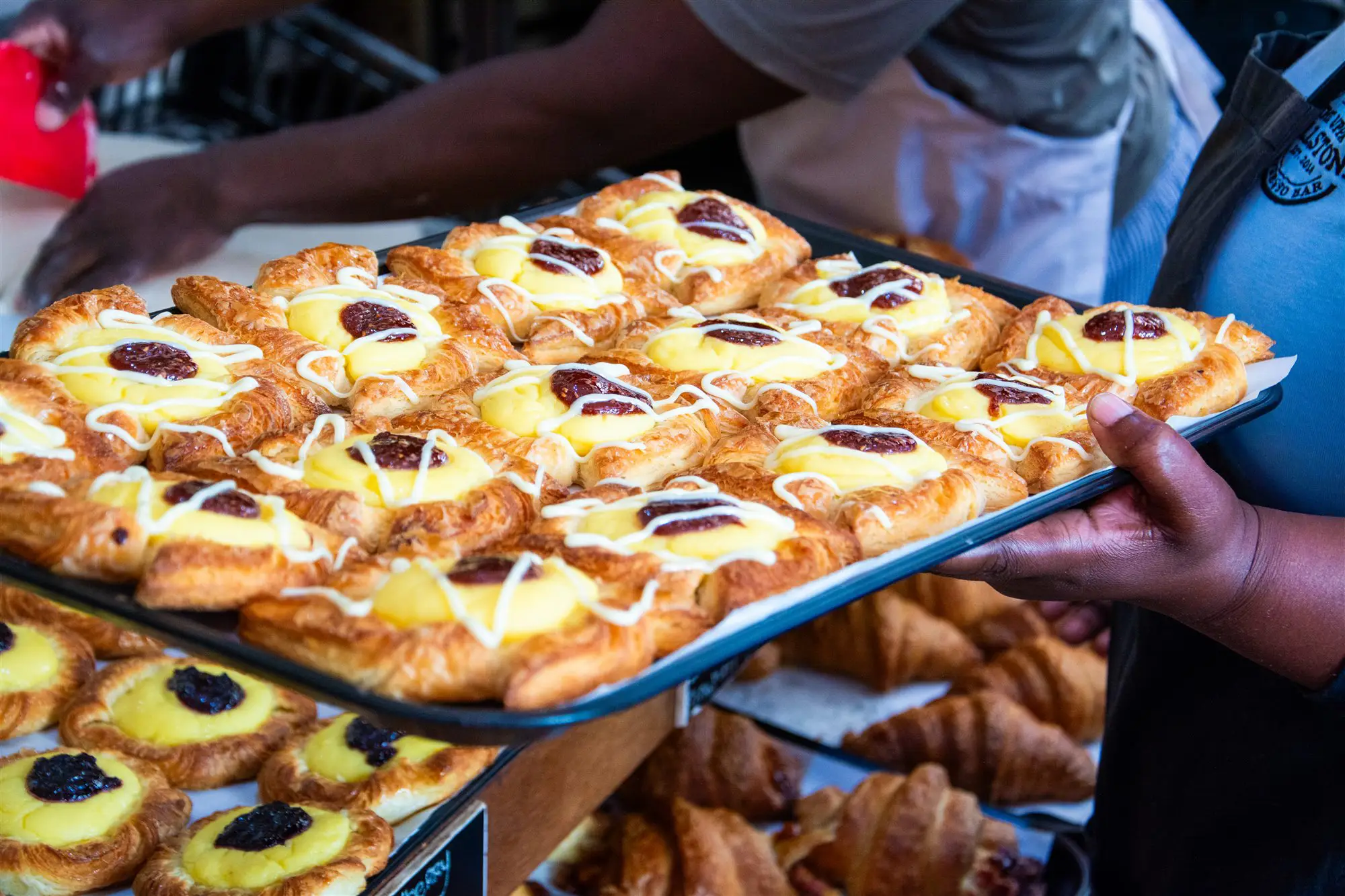 A tray piled high with fresh custard and jam Danish pastries, straight out of the oven — The Upper Millstone, Hilton